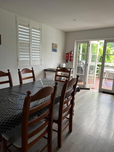 a dining room with a table and chairs and a door at 103B Mitre St Plantation House in Bathurst