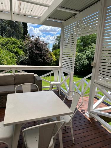 a patio with a table and chairs on a deck at 103B Mitre St Plantation House in Bathurst
