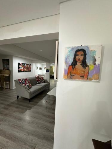a painting hanging on a wall in a living room at 103B Mitre St Plantation House in Bathurst