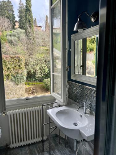 a bathroom with a sink and a window at Albero Mago in Florence