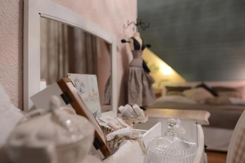 a dressing table with a mirror and a dress in a room at Gasthof zum Bären Birmenstorf GmbH in Birmenstorf