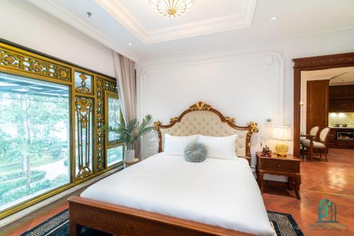 a bedroom with a bed and a large window at Luxe Paradise Suite Hotel Trich Sai in Hanoi