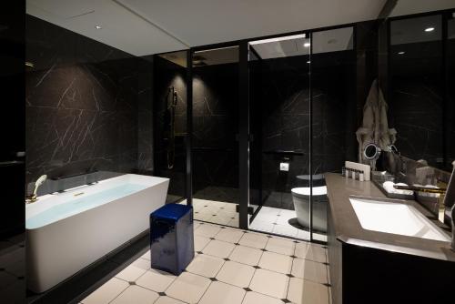 a bathroom with a tub and a sink and a toilet at BELLUSTAR TOKYO, A Pan Pacific Hotel in Tokyo