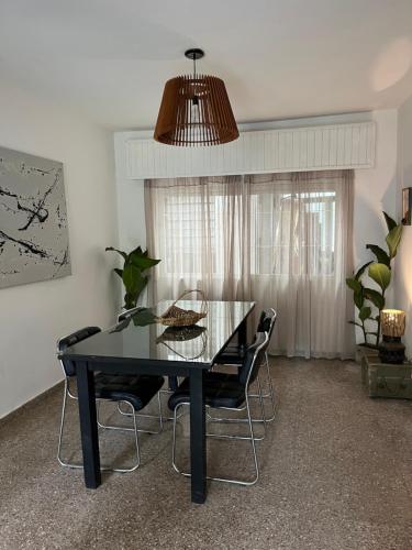 une salle à manger avec une table et des chaises noires dans l'établissement Casa Raíz, à Santa Rosa de Calamuchita