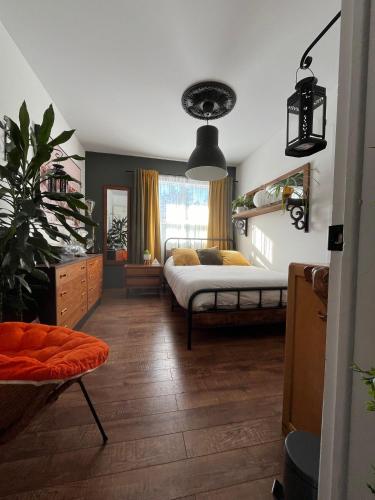 a bedroom with a bed and a large window at Le Refuge du Repaire in Saint-Alexis-des-Monts