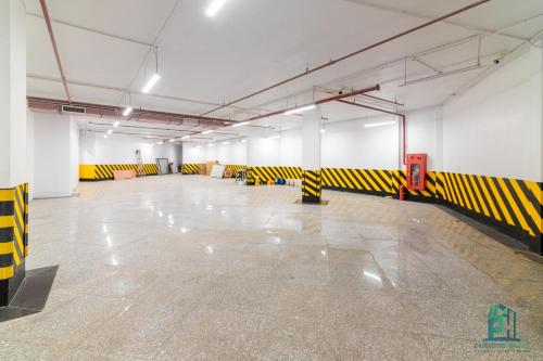 a large room with yellow and black barricades on the floor at Luxe Paradise Suite Hotel Trich Sai in Hanoi