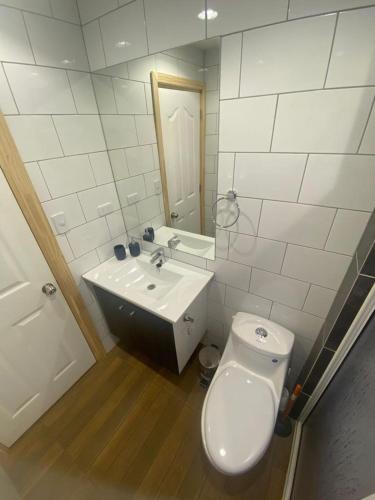 a bathroom with a white toilet and a sink at Cabañas loretito playa Chica Lican Ray in Licán Ray