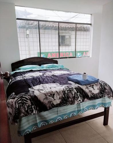 a bed sitting in a room with a window at Nuestro Señor del Camino in Cajamarca