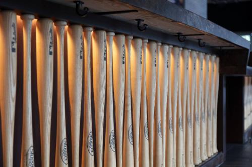 a row of wooden baseball bats lined up on a shelf at Marriott Marquis Houston in Houston