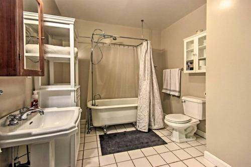 a bathroom with a tub and a toilet and a sink at Bear's Eye View - Mountain Retreat w/ Hot Tub! in Acme