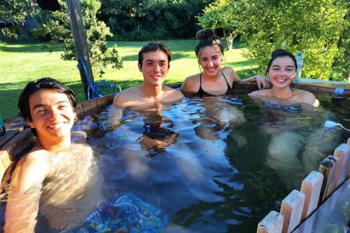 a group of people in a hot tub at MaPatagonia Hostel Monumento Nacional in Puerto Varas