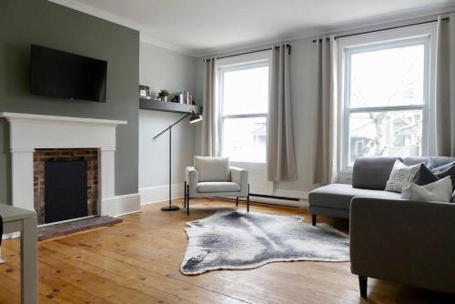 a living room with a couch and a fireplace at Historic Downtown Apt #2 in Halifax