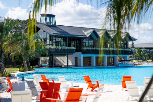 a resort with chairs and a swimming pool at Evermore Orlando Resort in Orlando