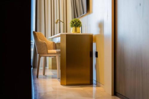 a desk with a chair and a potted plant on it at *Five Palm* 2bdr Private Beach in Dubai