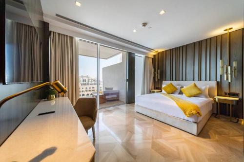 a bedroom with a bed and a desk in a room at *Five Palm* 2bdr Private Beach in Dubai