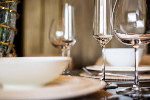 a table with three wine glasses and a bowl on it at *Five Palm* 2bdr Private Beach in Dubai
