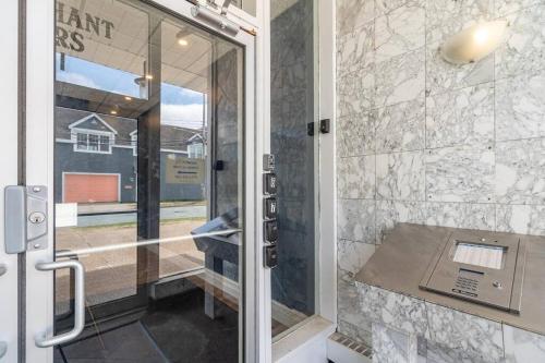 a bathroom with a shower with a glass door at Spacious Downtown Apt #9A, Amazing View in Halifax