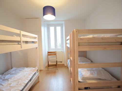 a room with two bunk beds and a lamp at Maison Lugrin, 7 pièces, 12 personnes - FR-1-498-100 in Lugrin