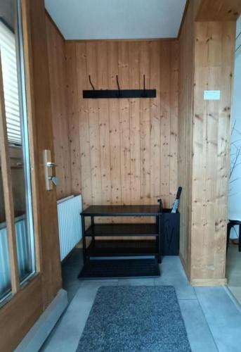 a room with a bench and a wooden wall at Ferienwohnung Falknis in Maienfeld mit Blick auf die Berge - b48844 in Maienfeld