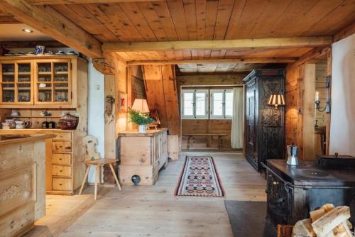 a kitchen with wooden floors and a wooden ceiling at Alphütte bei Lenk und Gstaad 