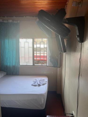 a small room with a bed and a window at Nuevo hospedaje benny in Melgar