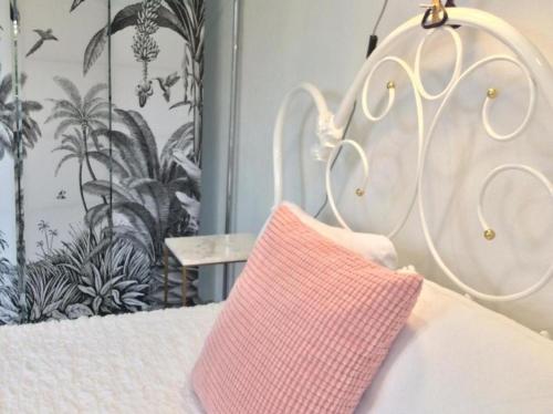 a close up of a bed with a pink pillow at Kleines, cooles Loft im Appenzellerland - b48859 in Gais