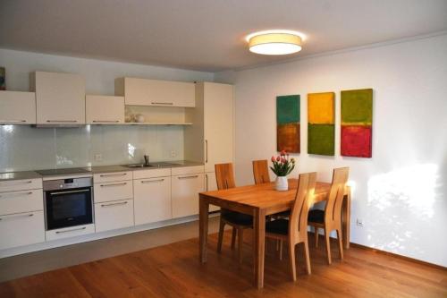 kuchnia ze stołem i krzesłami w pokoju w obiekcie Schmucke ruhige 25 Parterre Wohnung - b48866 w mieście Nottwil