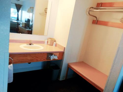 a bathroom with a sink and a mirror at Harbor Inn in Brookings