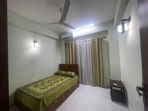 a bedroom with a bed and a ceiling fan at Mount Apartment in Ratmalana North
