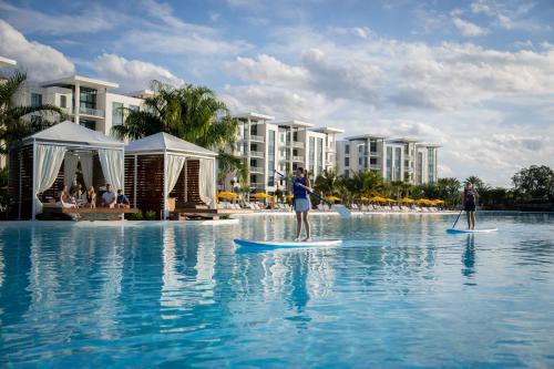 two people on surfboards in the water at a resort at Evermore Orlando Resort in Orlando