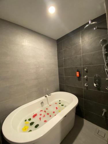 a bathroom with a bath tub with flowers on the floor at Super 8 Hotel Alor Setar in Alor Setar