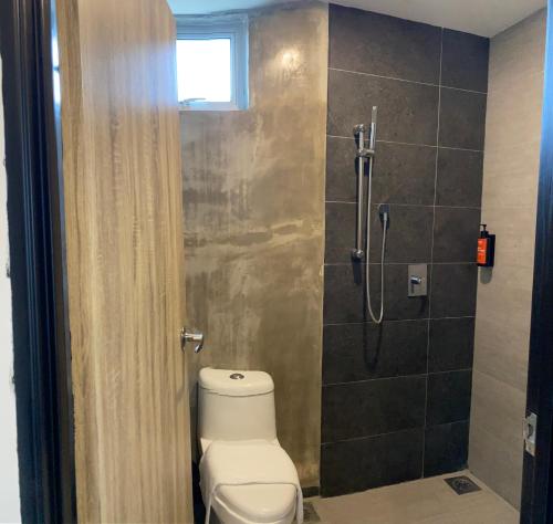 a bathroom with a toilet and a shower at Super 8 Hotel Alor Setar in Alor Setar