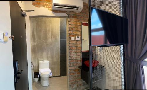a small bathroom with a toilet and a shower at Super 8 Hotel Alor Setar in Alor Setar