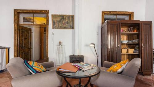 a living room with two couches and a table at Casa do Levante in Olhão
