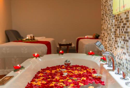 a bathroom with a bath tub filled with flowers at Havana Nha Trang Hotel in Nha Trang
