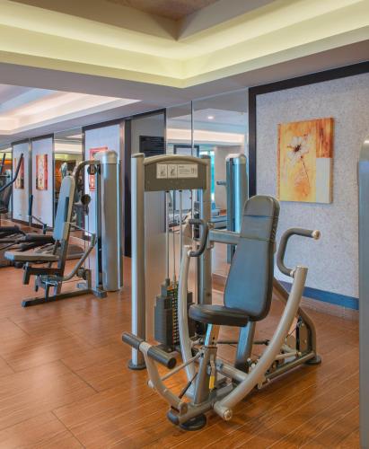 a gym with a row of treadmills and chairs at Havana Nha Trang Hotel in Nha Trang