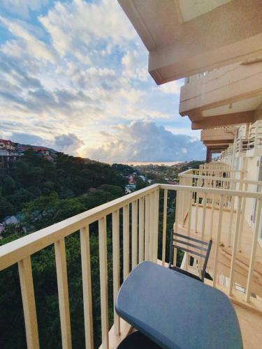 a blue bench sitting on a balcony with a view at BAGUIO CONDO TRANSIENT MOLDEX RESIDENCES by DEI GRATIA in Baguio