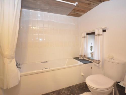 a bathroom with a white tub and a toilet at 1 bed in Tavistock ROUND in Lamerton