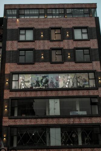 a tall building with a mural on the side of it at HOTEL 16 AVENUE in Kolkata