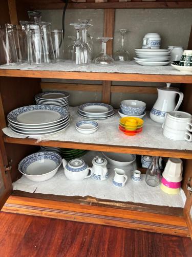 a cabinet filled with plates and cups and dishes at Grand view @lamaibeach in Koh Samui 