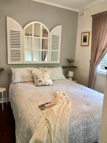 a bedroom with a bed with a book on it at MRS BROWN’s COMFY CITY PAD in Norwood