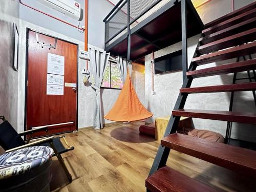 a room with a staircase and a bunk bed at Ardour Lodge "A" Wing in Tanjung Bungah