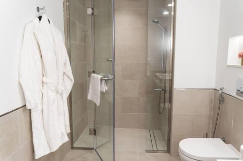 a bathroom with a glass shower with a toilet at Brand New l Stylish and Spacious 2BR in Madinat Jumeirah in Dubai
