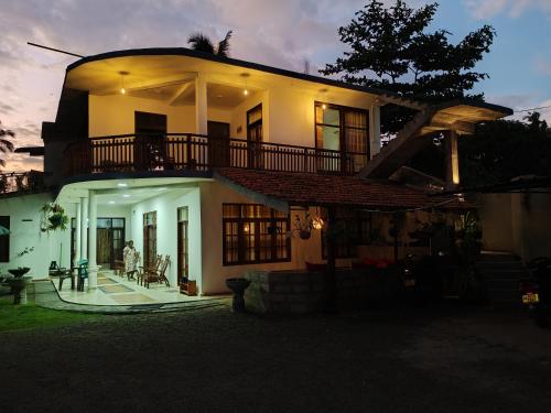 a large house with a balcony on top of it at Aurora Echo Villa in Matara