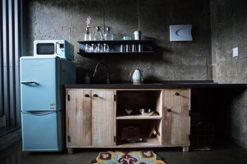 a kitchen with a blue refrigerator and a sink at SS Resort in Gapyeong