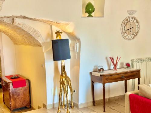 a living room with a giraffe lamp and a table at Trulli Moon in Alberobello