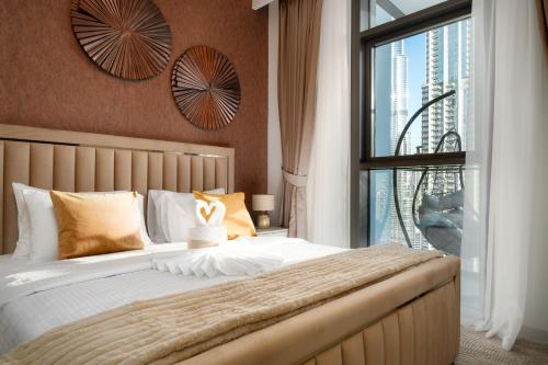 a bedroom with a large bed with a large window at Sky-High Central Dubai Gem: Burj Khalifa & Fountain View in Dubai