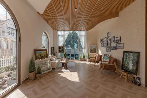 a living room with an arched ceiling and a large window at Jodi Dalat Hotel in Da Lat