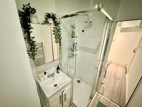 a bathroom with a sink and a shower at Downtown Chic Private Bedrooms in King's Cross 4 in London