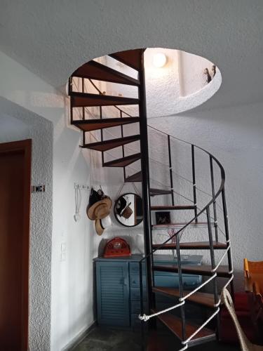 a spiral staircase in a room with a ceiling at Rebekka's Guest House Elani in Siviri